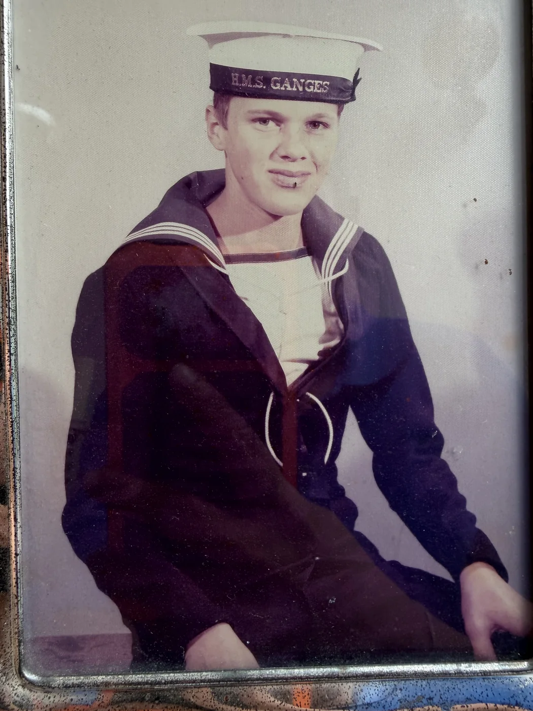 Young Marc in Royal Navy uniform, wearing a cap marked HMS Ganges